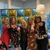 Five women posing and pointing at the camera in front of a colorful balloon backdrop with gold, blue, and white balloons at the Power Conference to ADVANCE Women in Energy - Las Vegas 2025, held at Southwest Gas Headquarters.